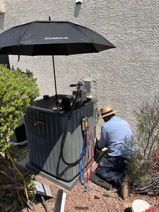 HVAC technician performing outdoor AC maintenance in Gloucester Point